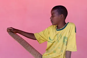 Kuranic school pupil holding a prayer tablet Kuranic school pupil holding a prayer tablet