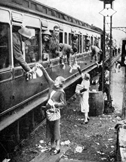 Local residents supplying refreshments to trainload of British soldiers who had been Local residents supplying refreshments to trainload of British soldiers who had been
