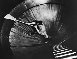 Man cleaning inside of huge kettle at brewery, Wisconsin Man cleaning inside of huge kettle at brewery, Wisconsin