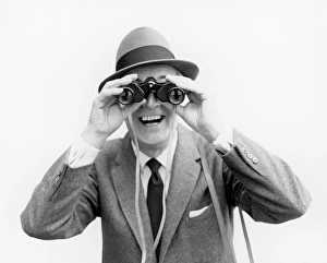 <b class=qtipBold><figcaption>Man looking through binoculars</figcaption></b> Man looking through binoculars