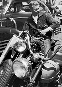 <b class=qtipBold><figcaption>Man On His Motorcycle</figcaption></b><br>San Francisco, California: c.1954 A biker sitting on his motorcycle.<br><em>© Underwood Archives/UIG</em> Man On His Motorcycle