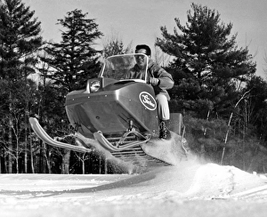 <b class=qtipBold><figcaption>A Man Riding A Snowmobile</figcaption></b><br>United States: c. 1964 A man riding a snowmobile as he goes over a low hill and goes airborne. His Johnson Skee Horse can achieve speeds of 30 mph.<br><em>© Underwood Archives/UIG</em> A Man Riding A Snowmobile