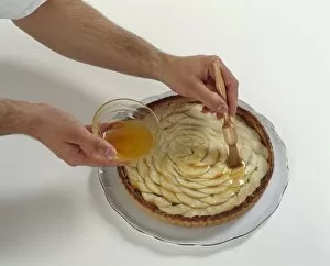 Basting Brush Gallery: Man using basting brush to coat sliced raw apples on pastry tart with apricot glaze