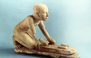 Model of a baker kneading dough and forming loaves. Ancient Egyptian Model of a baker kneading dough and forming loaves. Ancient Egyptian
