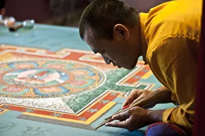 Monk drawing a Mandala in Dashan Kagyu Ling buddhist temple in Burugundy (France) Monk drawing a Mandala in Dashan Kagyu Ling buddhist temple in Burugundy (France)