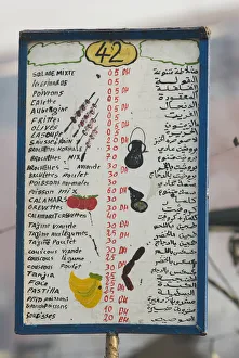 Morocco, Marrakech, Djemaa el Fna, food stall menu board in Arabic and Western script Morocco, Marrakech, Djemaa el Fna, food stall menu board in Arabic and Western script