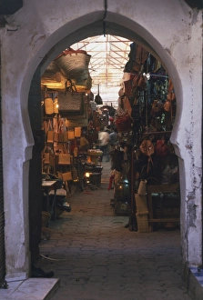 Morocco, Marrakech, Souk el-Batna, stalls of skinners souk seen though hoof-shaped doorway Morocco, Marrakech, Souk el-Batna, stalls of skinners souk seen though hoof-shaped doorway
