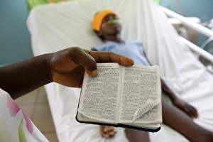 Mother reading a bible in her childs hospital room Mother reading a bible in her childs hospital room