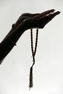 Muslim woman holding islamic prayer beads Muslim woman holding islamic prayer beads