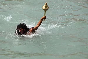Naga sadhu bathing in the river Ganges on the occasion of Somvati Amavasya Naga sadhu bathing in the river Ganges on the occasion of Somvati Amavasya