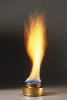 Natural gas burner and large orange and blue flame, close-up Natural gas burner and large orange and blue flame, close-up