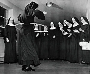 Images Dated 3rd February 2014: Nun Swivels Hula Hoop On Hips