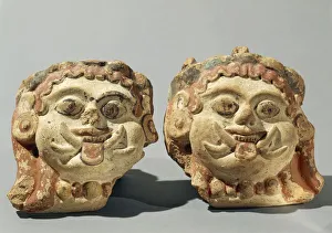 Ornamental elements representing two Gorgon heads, terracotta Ornamental elements representing two Gorgon heads, terracotta