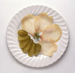 Osetrina, slices of sturgeon and gherkins, a traditional Russian dish, view from above Osetrina, slices of sturgeon and gherkins, a traditional Russian dish, view from above