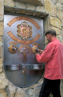 Pilgrim drinking wine at the Irache water and Rioja wine fountain on the Camino of Pilgrim drinking wine at the Irache water and Rioja wine fountain on the Camino of