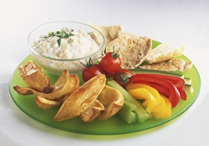 Pitta, chips, crudites and dip, served on a plate Pitta, chips, crudites and dip, served on a plate