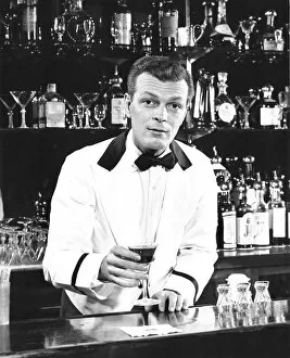 Portrait of a bartender holding a drink