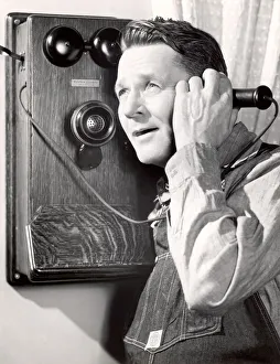 Portrait of a man using a telephone Portrait of a man using a telephone