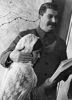 Propaganda photo of josef stalin as benevolent father figure with eleven year old Propaganda photo of josef stalin as benevolent father figure with eleven year old
