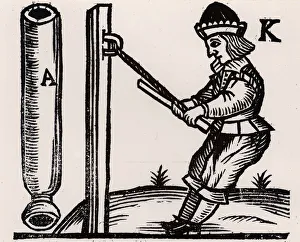 A Pyrotechnist or Firework-maker making a rocket. He is pulling the end of a rocket A Pyrotechnist or Firework-maker making a rocket. He is pulling the end of a rocket