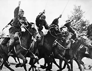 Red army cavalry charge with sabers drawn, following the tanks into the action Red army cavalry charge with sabers drawn, following the tanks into the action
