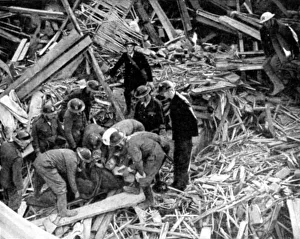 Rescue workers releasing injured person from the debris of a building destroyed by Rescue workers releasing injured person from the debris of a building destroyed by