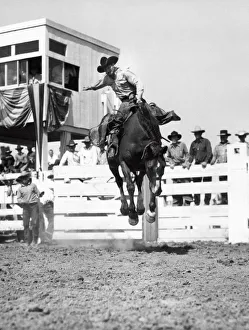 <b class=qtipBold><figcaption>Riding A Bucking Bronco</figcaption></b><br>United States: July, 1935. A cowboy doing his best to stay on a bucking bronco at a local rodeo.<br><em>© Underwood Archives/UIG</em> Riding A Bucking Bronco