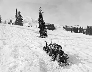 <b class=qtipBold><figcaption>Riding Down A Glacier</figcaption></b><br>Ranier National Park, Washington: c. 1927 One of the main summer snow amusements at Rainier National Park. The participants are given 'tin breeches' for their thrilling ride down the mountain. This group is ready to go.<br><em>© Underwood Archives/UIG</em> Riding Down A Glacier