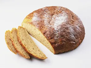 Round loaf of wild mushroom bread with some slices removed, high angle view Round loaf of wild mushroom bread with some slices removed, high angle view