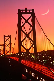 San Francisco Bay Bridge from Treasure Island with crescent moon at sunset San Francisco Bay Bridge from Treasure Island with crescent moon at sunset