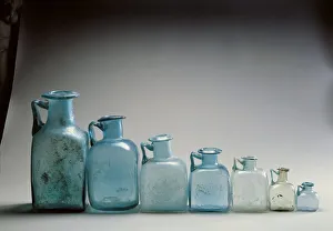 Seven blue glass bottles, used as measures of capacity, from Pompei Seven blue glass bottles, used as measures of capacity, from Pompei