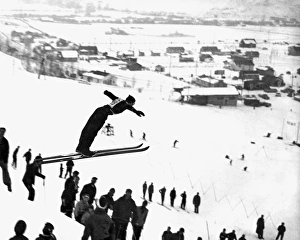 <b class=qtipBold><figcaption>A Ski Jump On A Snowy Day</figcaption></b><br>United States: c. 1957. A skier takes off the in the air and shows great form in this winter scene.<br><em>© Underwood Archives/UIG</em> A Ski Jump On A Snowy Day