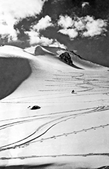 <b class=qtipBold><figcaption>Skiing In The Canadian Rockies</figcaption></b><br>Canada: c. 1955 A lone skier coming down a long slope on a mountain in the Canadian Rockies<br><em>© Underwood Archives/UIG</em> Skiing In The Canadian Rockies