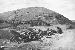 Soldiers collecting cartridges from dead before burial