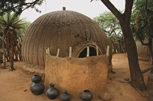 South Africa, pots and a leather hide screen in front of a hut built from a wooden South Africa, pots and a leather hide screen in front of a hut built from a wooden