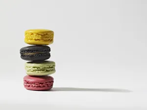 Stack of four yellow, brown, green and pink macaroons Stack of four yellow, brown, green and pink macaroons