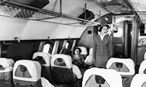 A stewardess and passengers aboard a tu-114 airliner (at the time, the worlds largest) A stewardess and passengers aboard a tu-114 airliner (at the time, the worlds largest)
