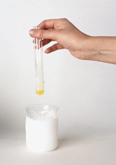 Test tube of chlorine condensed into liquid by dipping into jug of dry ice Test tube of chlorine condensed into liquid by dipping into jug of dry ice