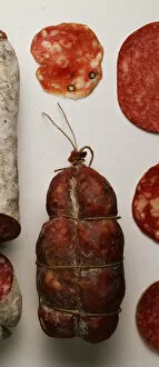 Cholesterol Collection: Tightly strung and wound Country Style Salami, with dark brown casing from heavy smoking