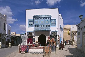 Tunisia, Kairouan, Old Town, Bourguiba Avenue, typical blue balcony and carpet sellers Tunisia, Kairouan, Old Town, Bourguiba Avenue, typical blue balcony and carpet sellers