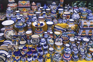USA, Mexico, brightly coloured glazed ceramics for sale on market stall, high angle view USA, Mexico, brightly coloured glazed ceramics for sale on market stall, high angle view