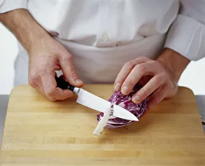 Using kitchen knife to remove hard core from centre of red cabbage slice Using kitchen knife to remove hard core from centre of red cabbage slice