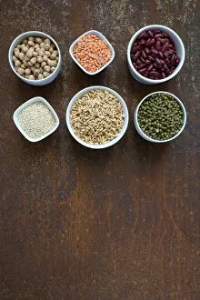 Variety of uncooked superfood cereals, chia, red lentils, pearl spelled, red beans, chickpeas