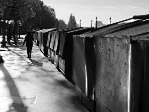 Walking by stalls on the Seine Embankment at sunset Walking by stalls on the Seine Embankment at sunset