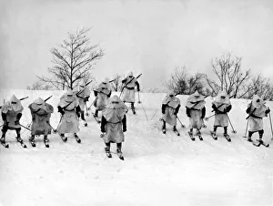 <b class=qtipBold><figcaption>Winter Warfare Maneuvers</figcaption></b><br>Pine Camp, New York: January, 1940. Taking winter warfare lessons from the Finns, men of the 28th Infantry ski down a slope during winter maneuvers.<br><em>© Underwood Archives/UIG</em> Winter Warfare Maneuvers