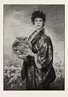 A Woman Holding A Fishbowl Containing Gold Fish