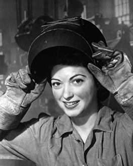 Woman wearing welding mask and gloves in wartime Woman wearing welding mask and gloves in wartime