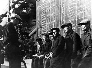 Workers studying diagrams indicating the output accomplished at the blast furnace shop of Workers studying diagrams indicating the output accomplished at the blast furnace shop of