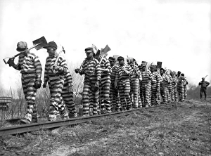 <b class=qtipBold><figcaption>Working On The Chain Gang</figcaption></b><br>Macon, Georgia March 8, 1937 A Bibb County chain gang with picks and shovels returns from work for the day. The county recently instituted an eight hour day for the convicts.<br><em>© Underwood Archives/UIG</em> Working On The Chain Gang
