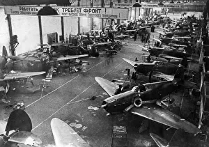 Yak-1 fighter planes being built in the assembly shop of a soviet aircraft factory during Yak-1 fighter planes being built in the assembly shop of a soviet aircraft factory during